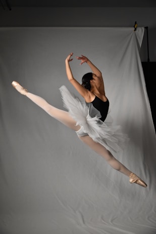 A dynamic action shot of a dancer mid-leap, showcasing movement and grace.