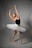 A dancer poses gracefully in a ballet position. She wears a black leotard paired with a white tutu, her arms elegantly extended above her head. The background is a plain, soft gray, and her feet are in pointe shoes, reflecting the discipline and artistry of ballet.