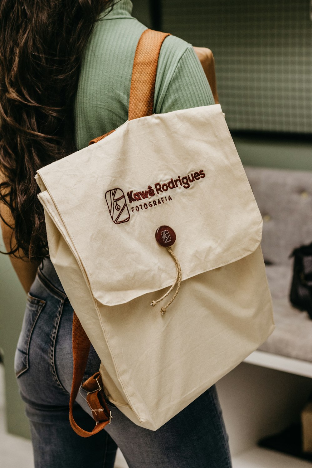 a woman carrying a bag with a logo on it