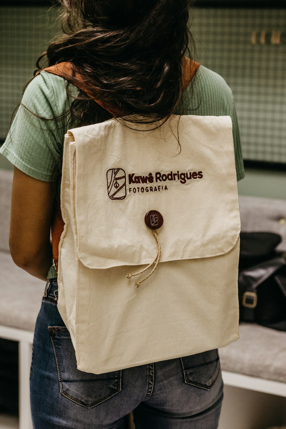 a woman carrying a bag with a logo on it