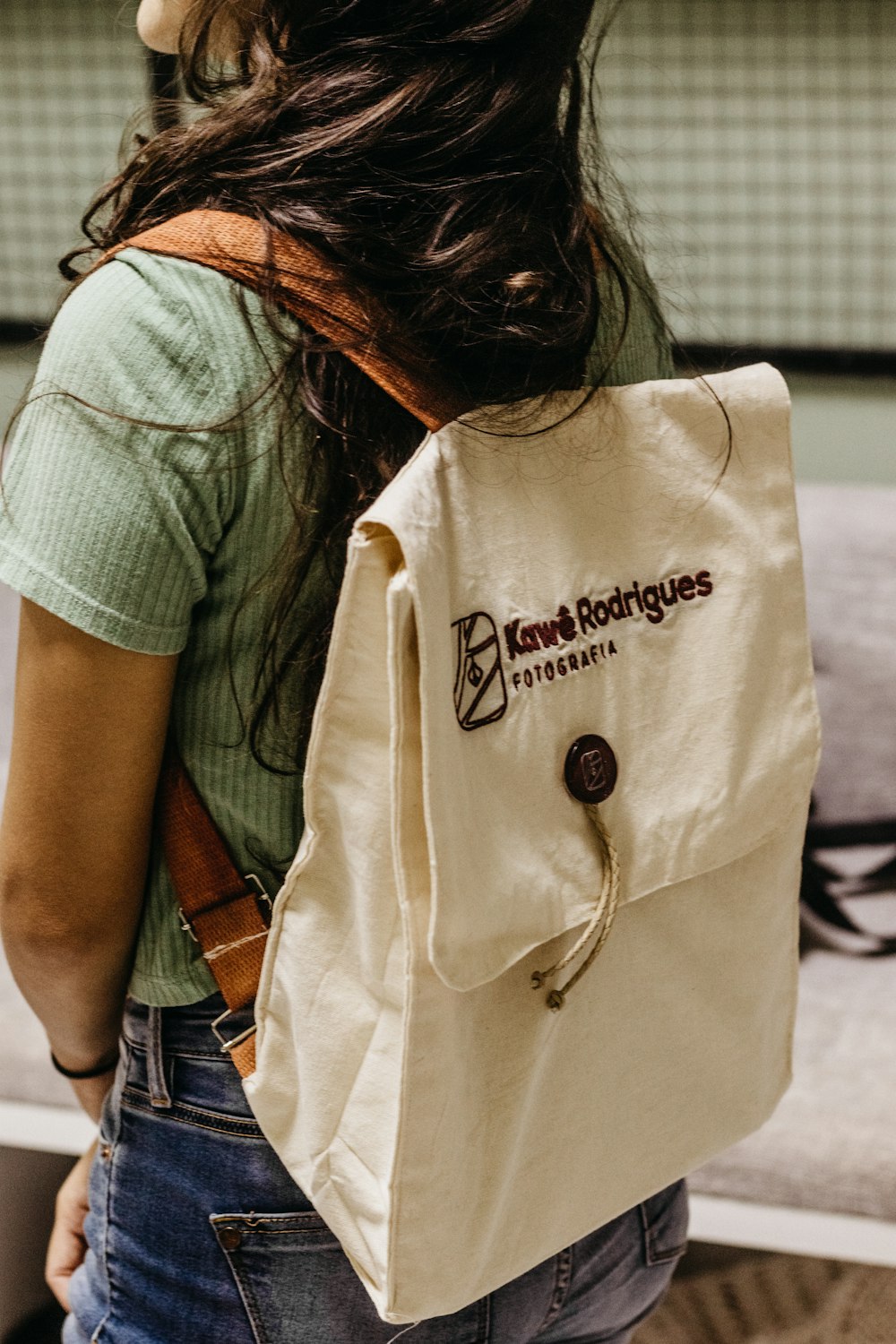 a woman carrying a bag with a logo on it