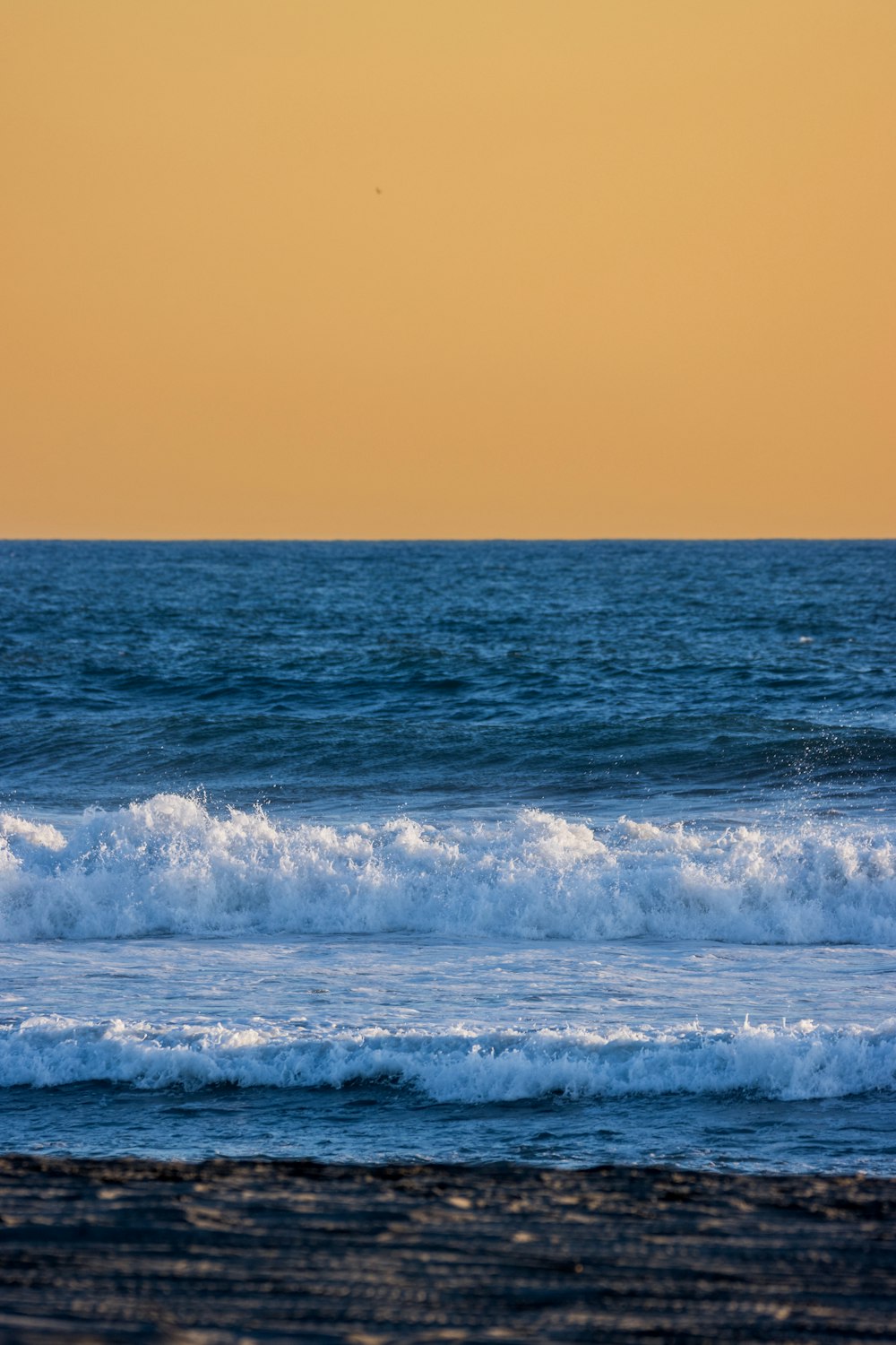 a person riding a surfboard on a wave in the ocean