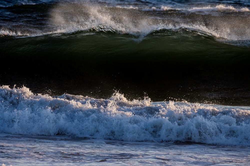 a person riding a surfboard on a wave in the ocean