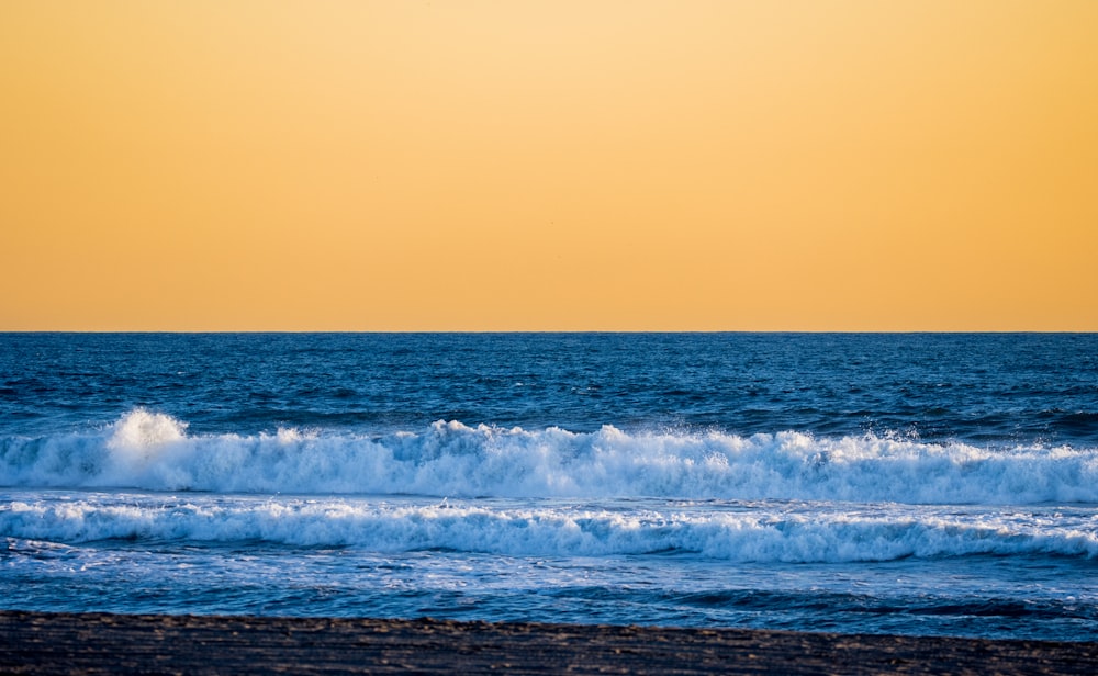 a large body of water with waves coming in to shore