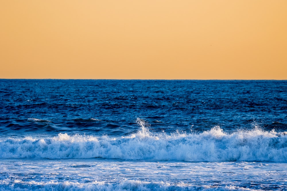 a person riding a surfboard on a wave in the ocean