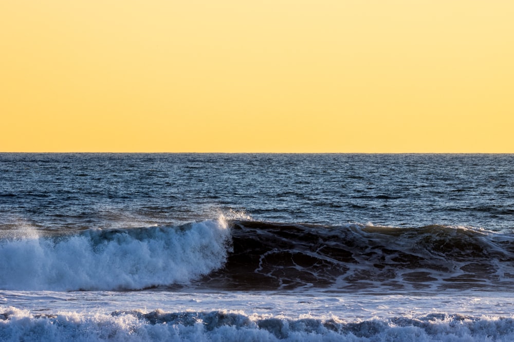 a person riding a surfboard on a wave in the ocean