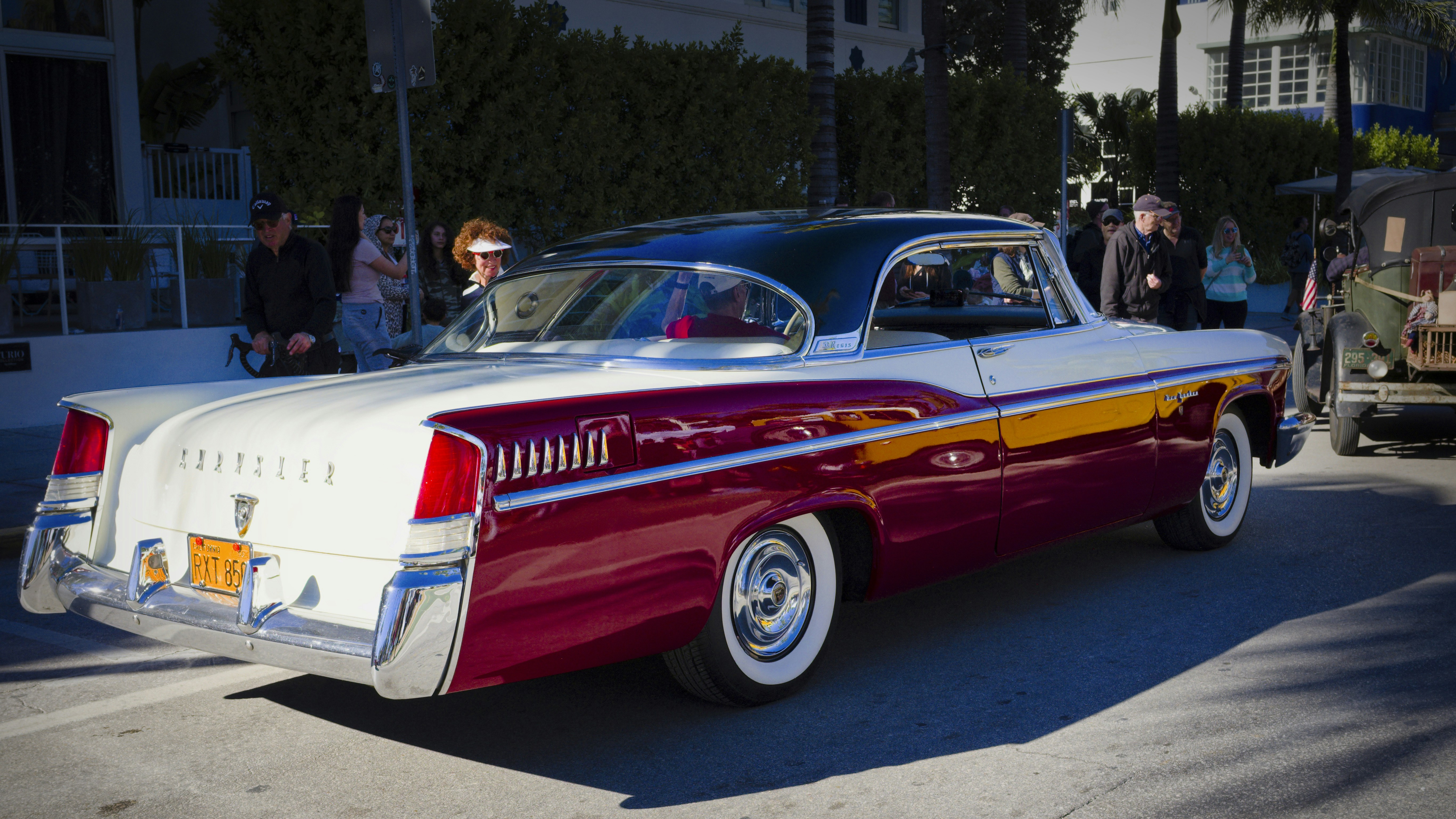 a red and white car parked in a parking lot