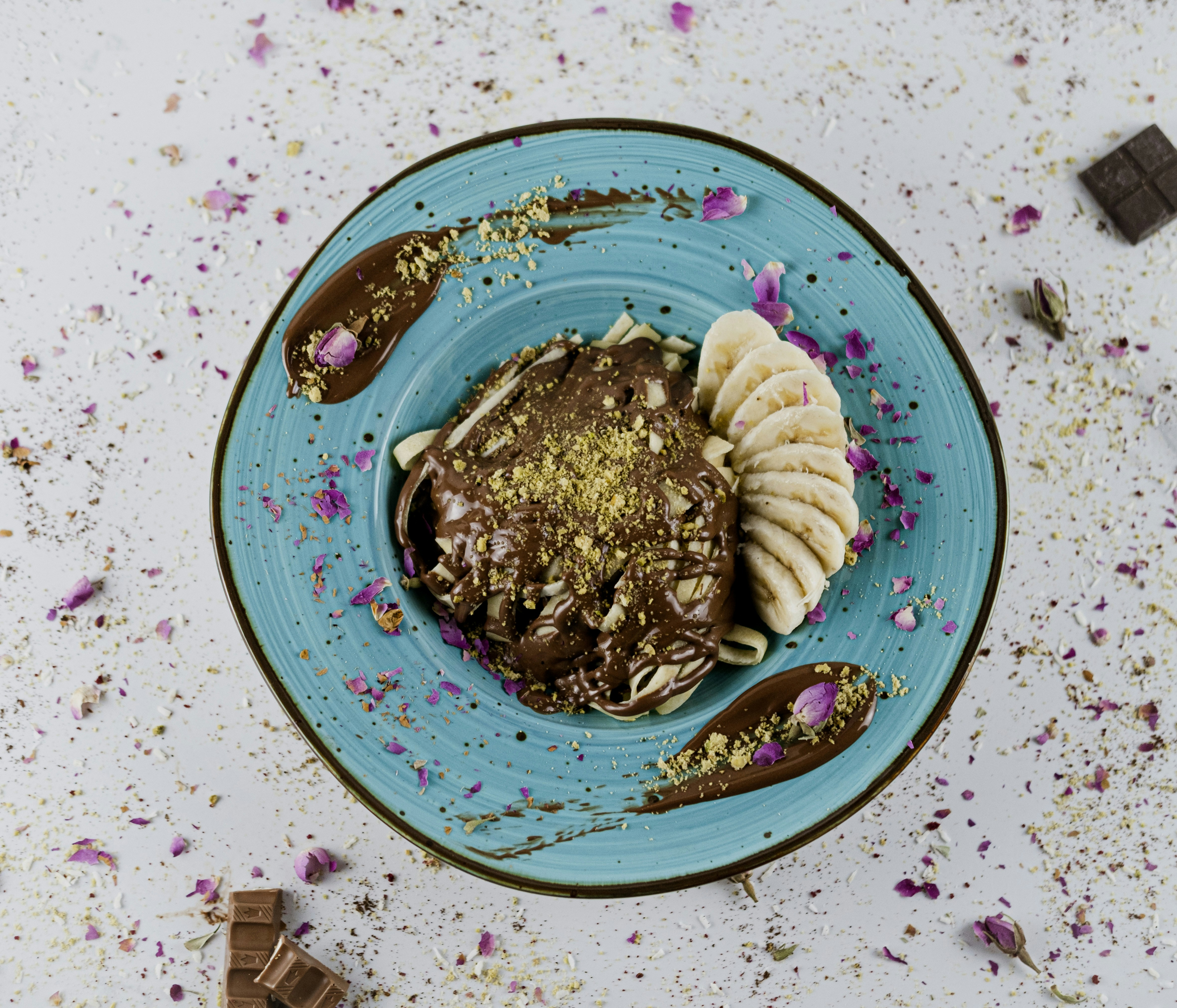 Chocolate oat bowl with banana on a blue plate