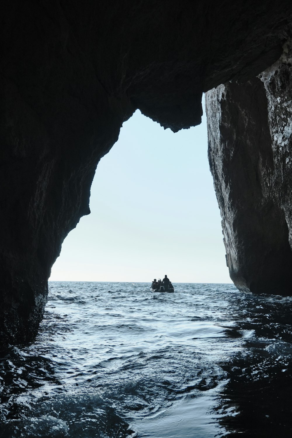 a couple of people in a small boat in a body of water