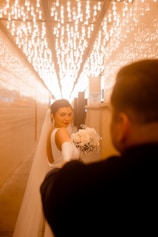 a woman in a wedding dress standing next to a man