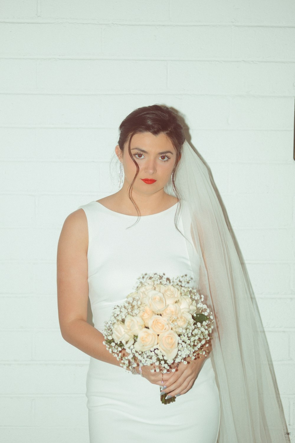 a woman in a white dress holding a bouquet of flowers