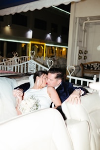 A couple sitting together with a coach, discussing wedding plans in a cozy setting.