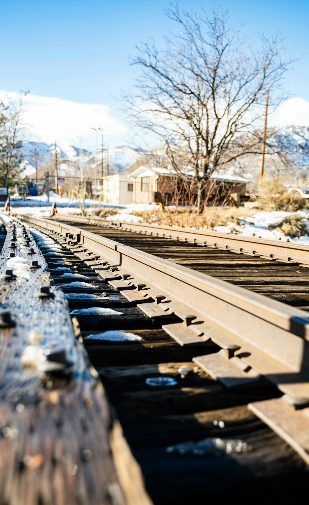 a train track with snow on the ground