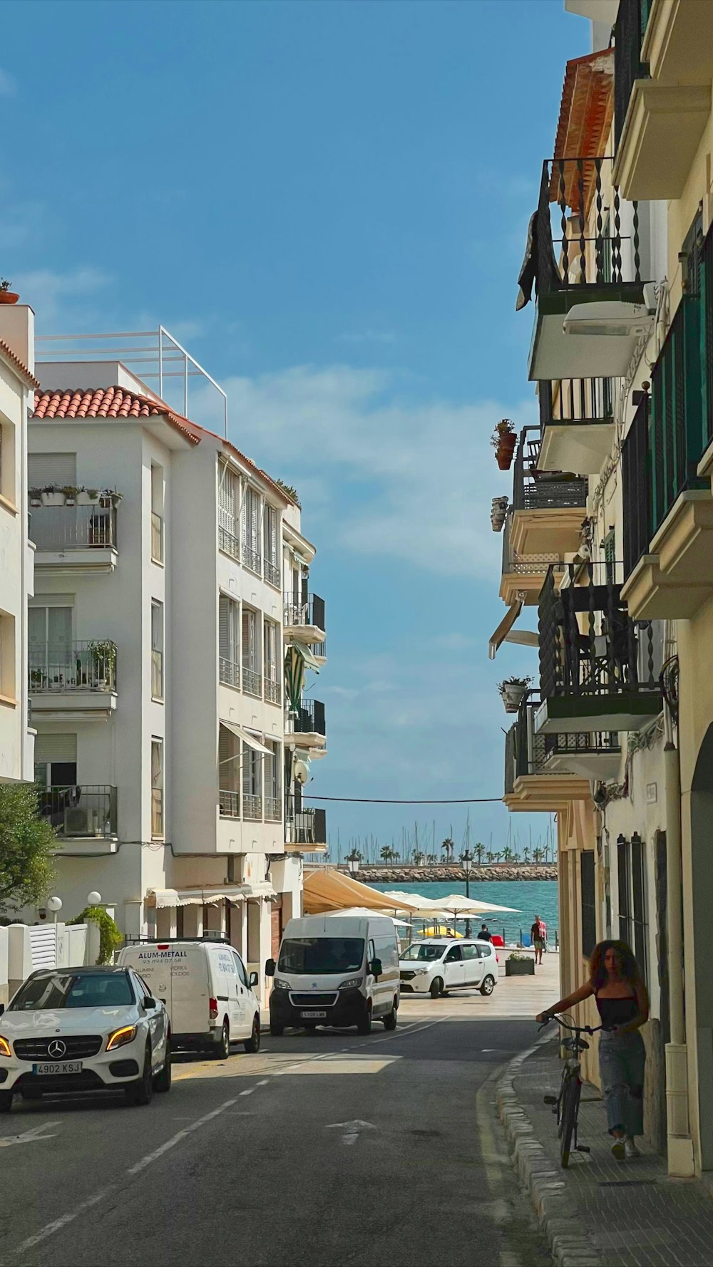 a man riding a bike down a street next to tall buildings