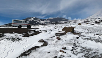 A technician assessing a vehicle’s emergency preparedness in a snowy landscape.