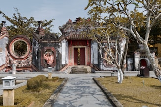 Entrance gate of Sai Ashram Bhaktaniwas with clear signage and a calm pathway