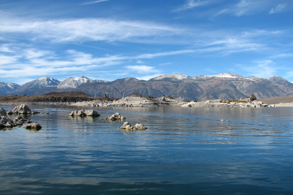 a body of water with mountains in the background