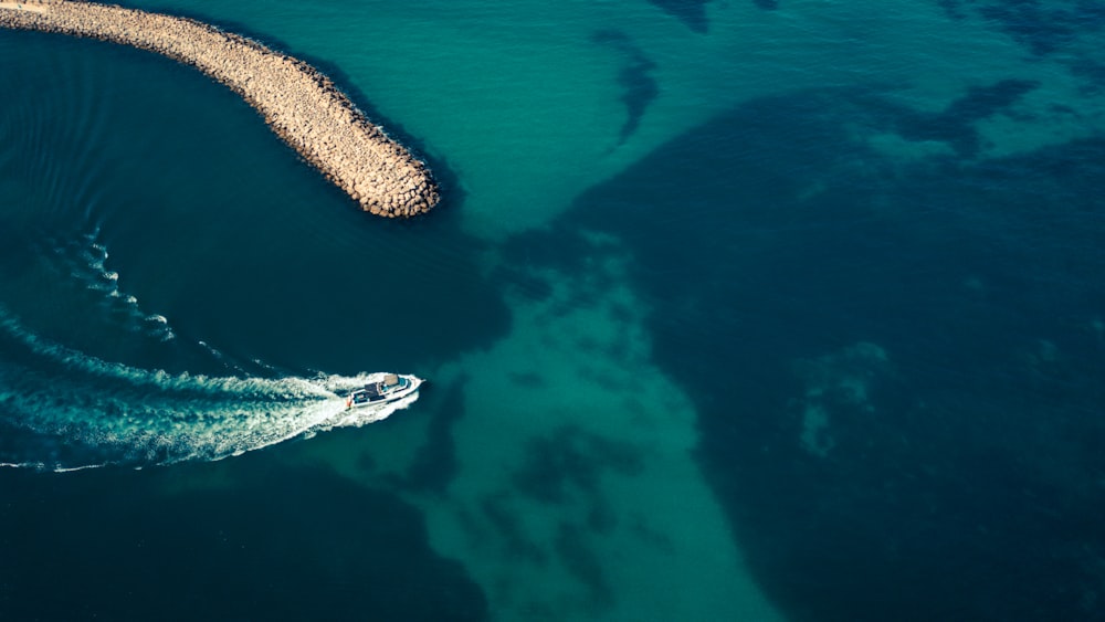 an aerial view of a boat in a body of water