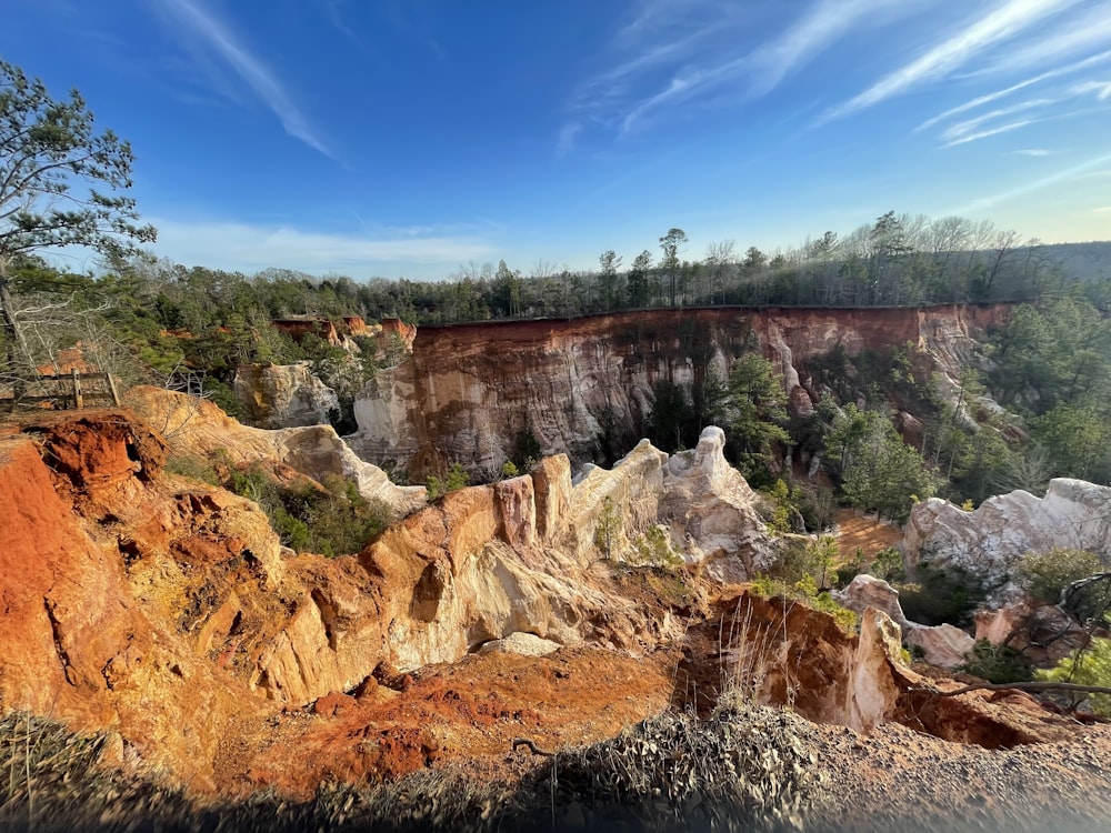 a scenic view of a cliff with a bridge in the distance