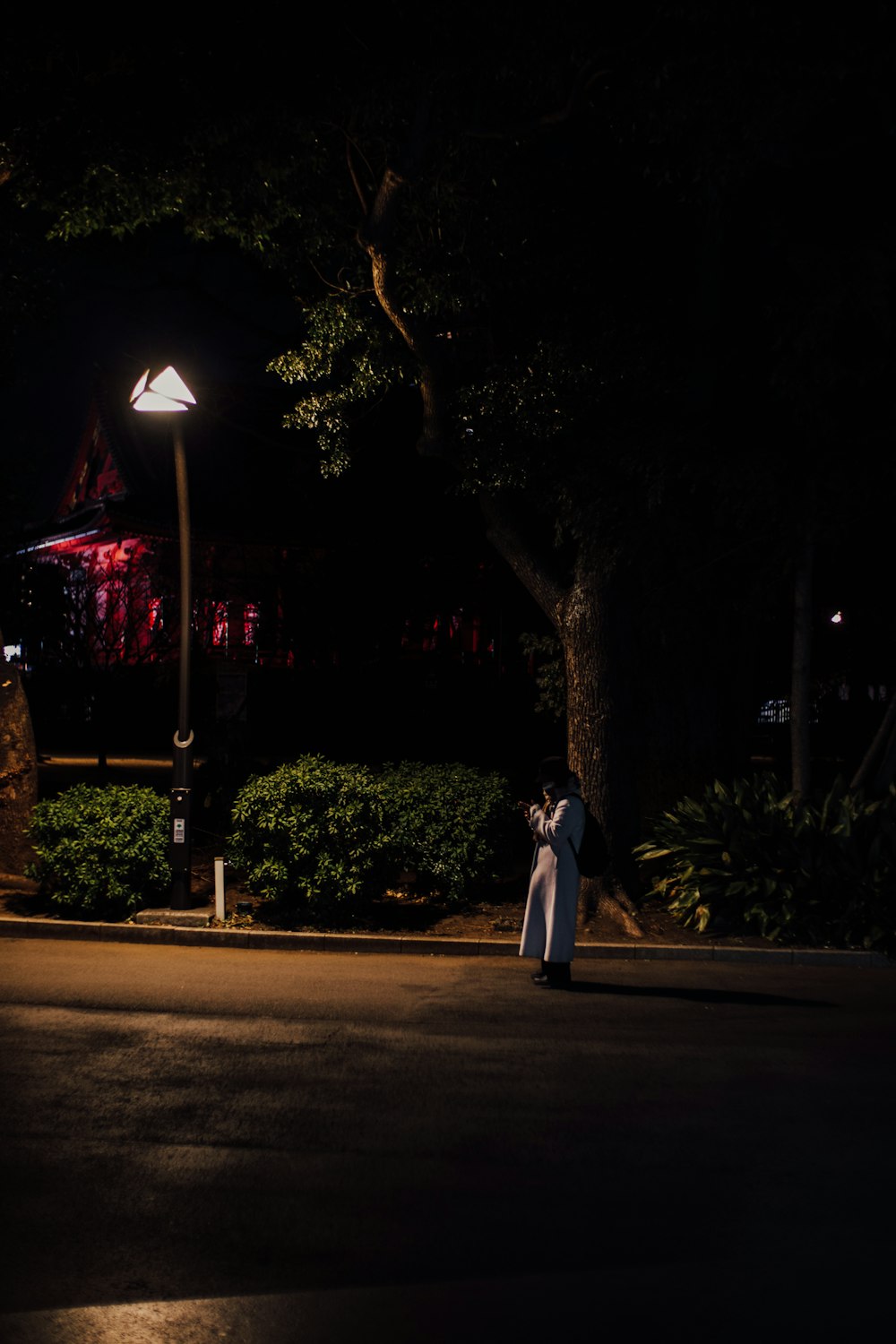 a person standing on a street at night