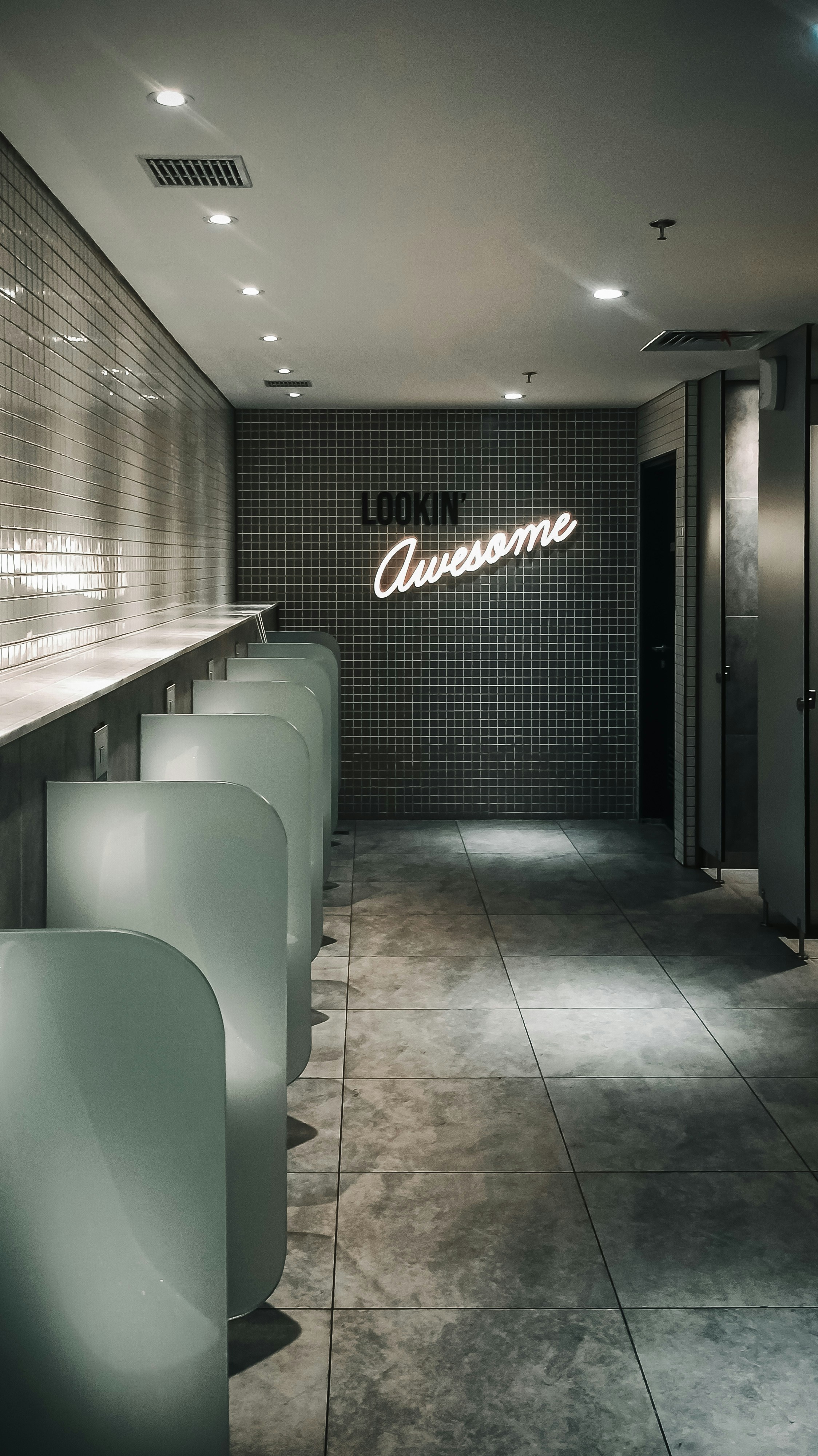 a long row of white chairs sitting next to a wall