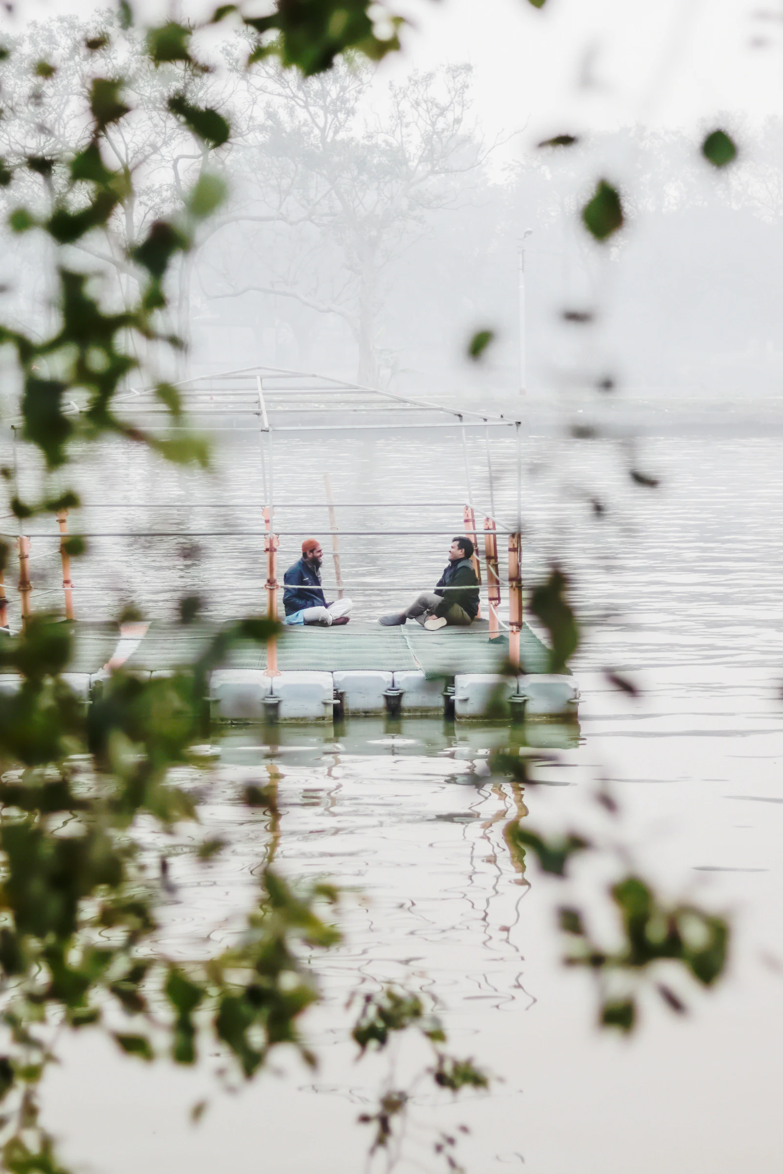 Friends laughing together in a boat on a lake