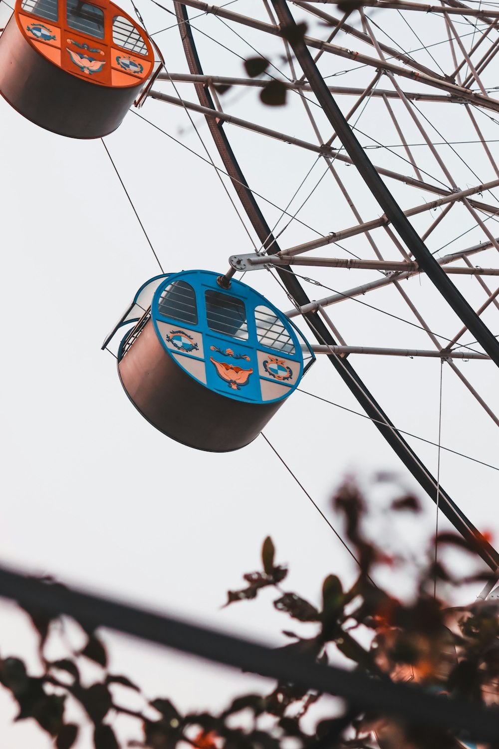 a ferris wheel with two blue and orange seats