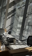 Modern office desk with paperwork and a coffee cup in natural light