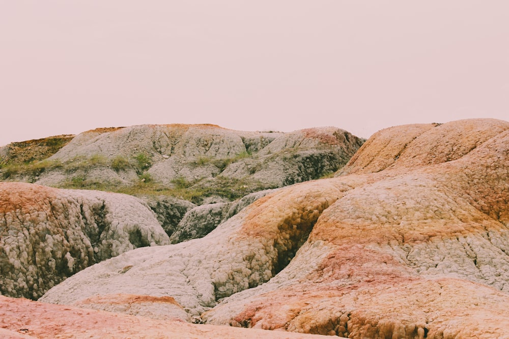 a person standing on top of a large rock formation