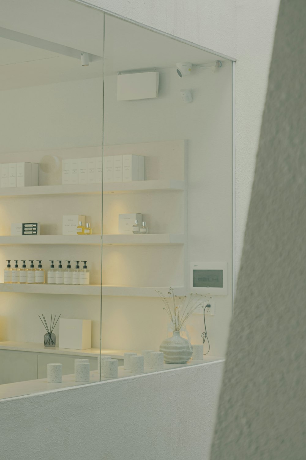 a white room with a large mirror and shelves