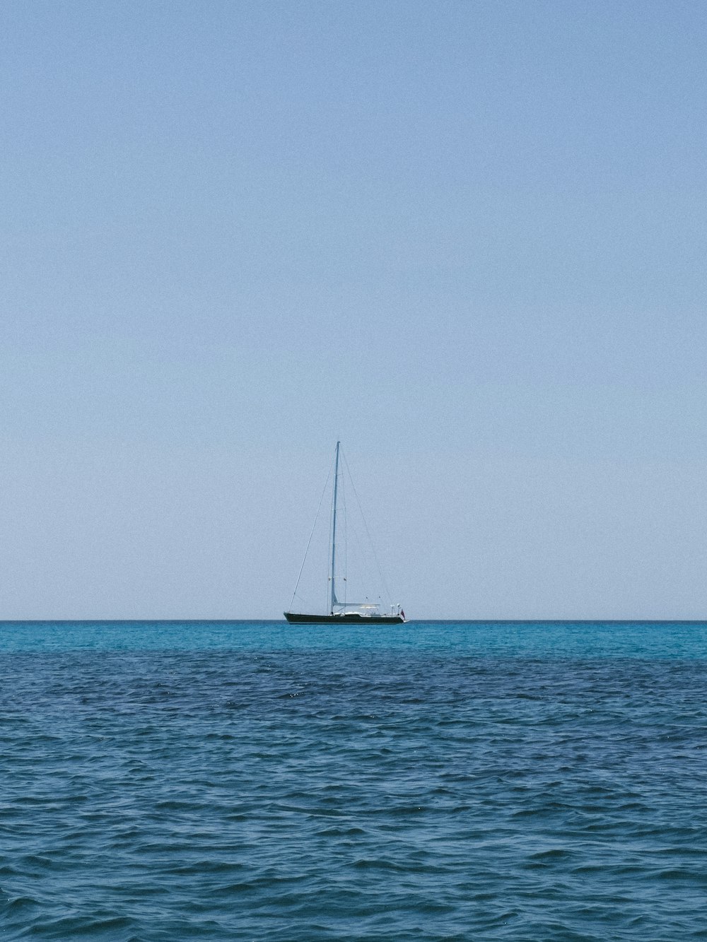 a sailboat in the middle of the ocean