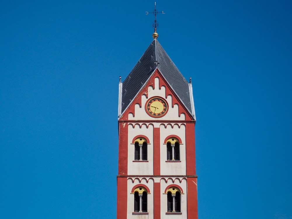 a tall clock tower with a clock on each of it's sides