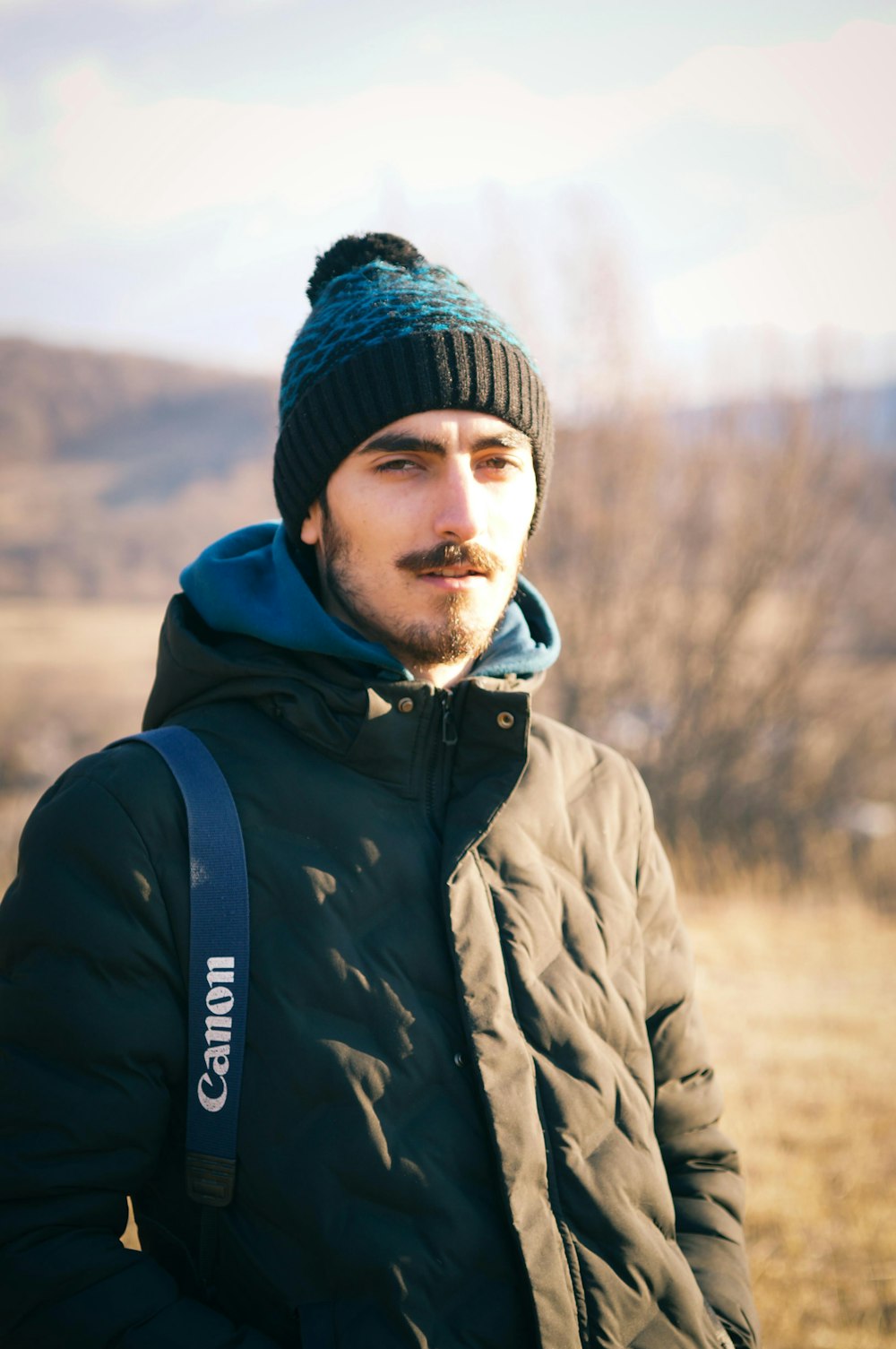 a man with a beard wearing a beanie