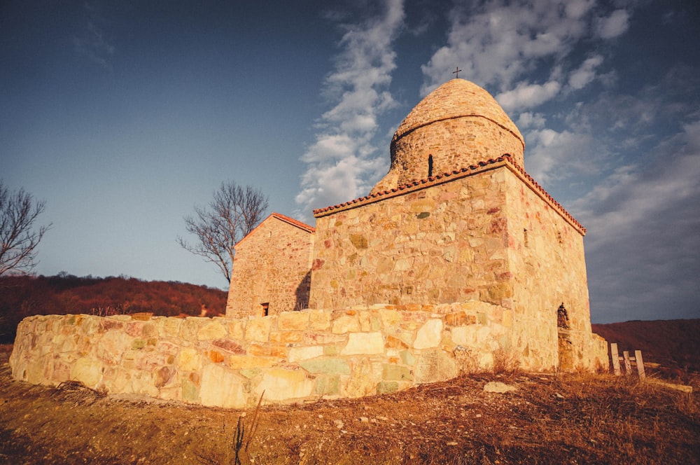 a stone building with a steeple on top of it