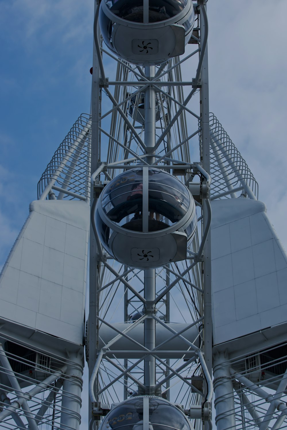 a very tall metal structure with a clock on it