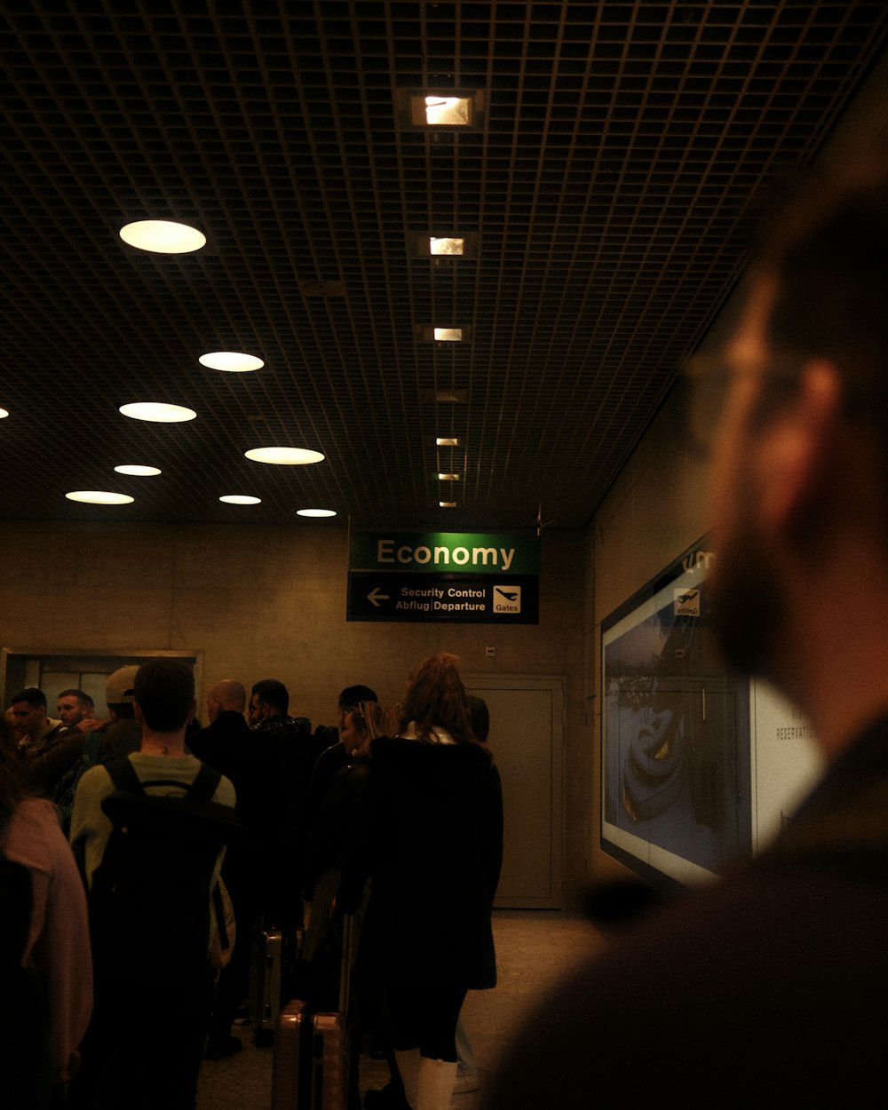 a group of people waiting in line at an airport