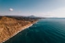 an aerial view of the ocean and mountains