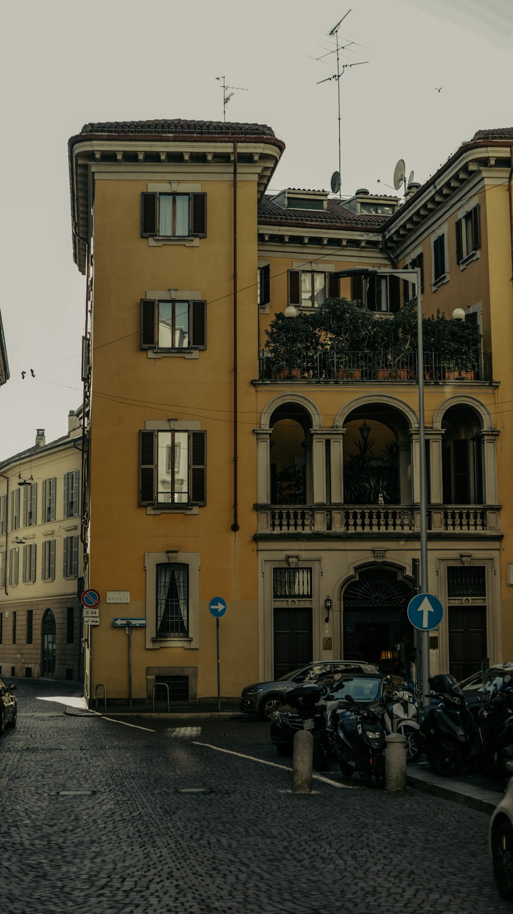 a yellow building with balconies and balconies on top of it