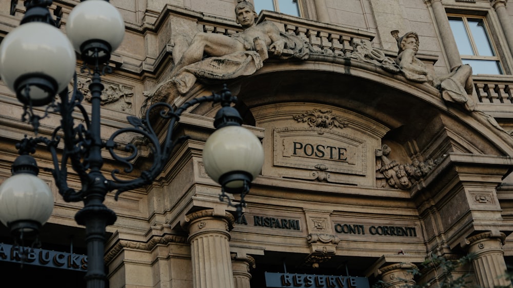 a street light and a post office sign on a building