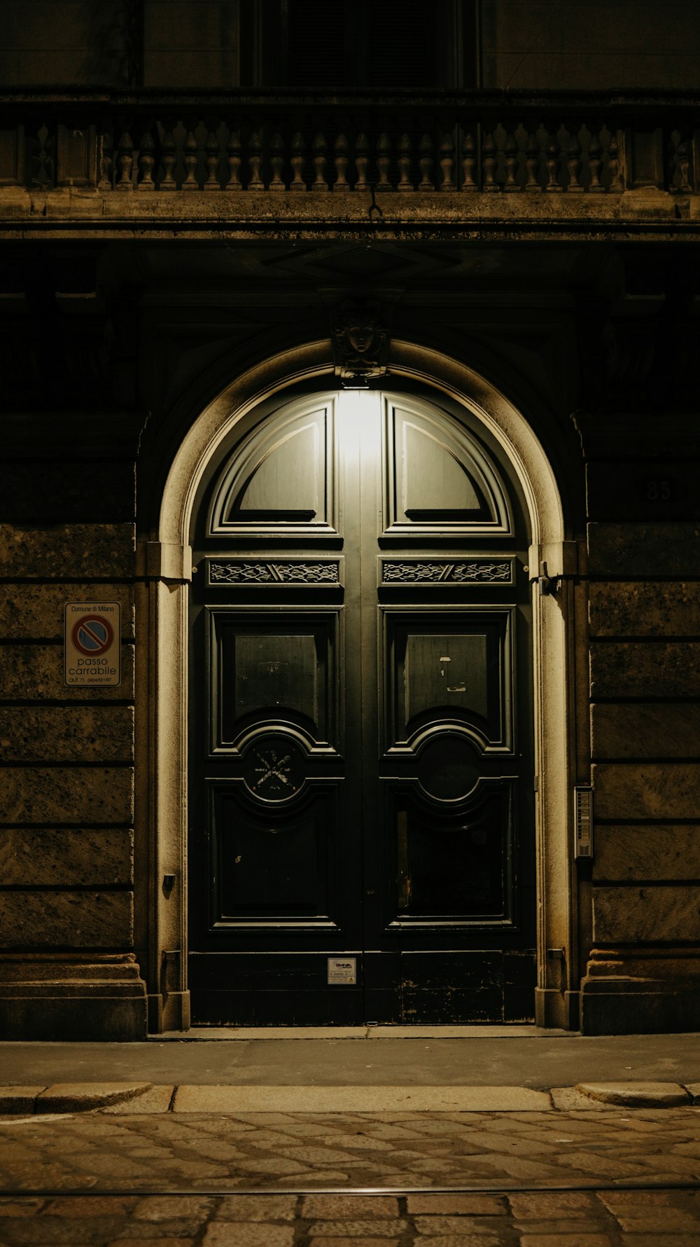 a black door with a light shining on it