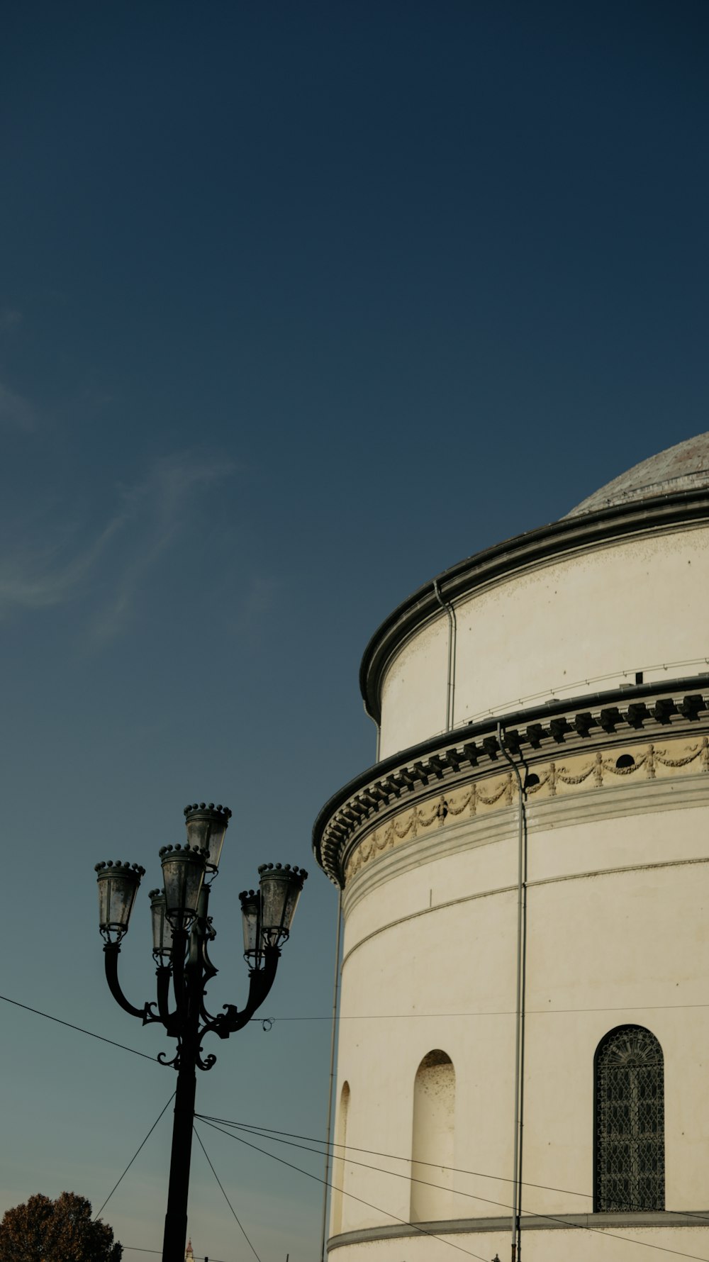 a white building with a light pole next to it