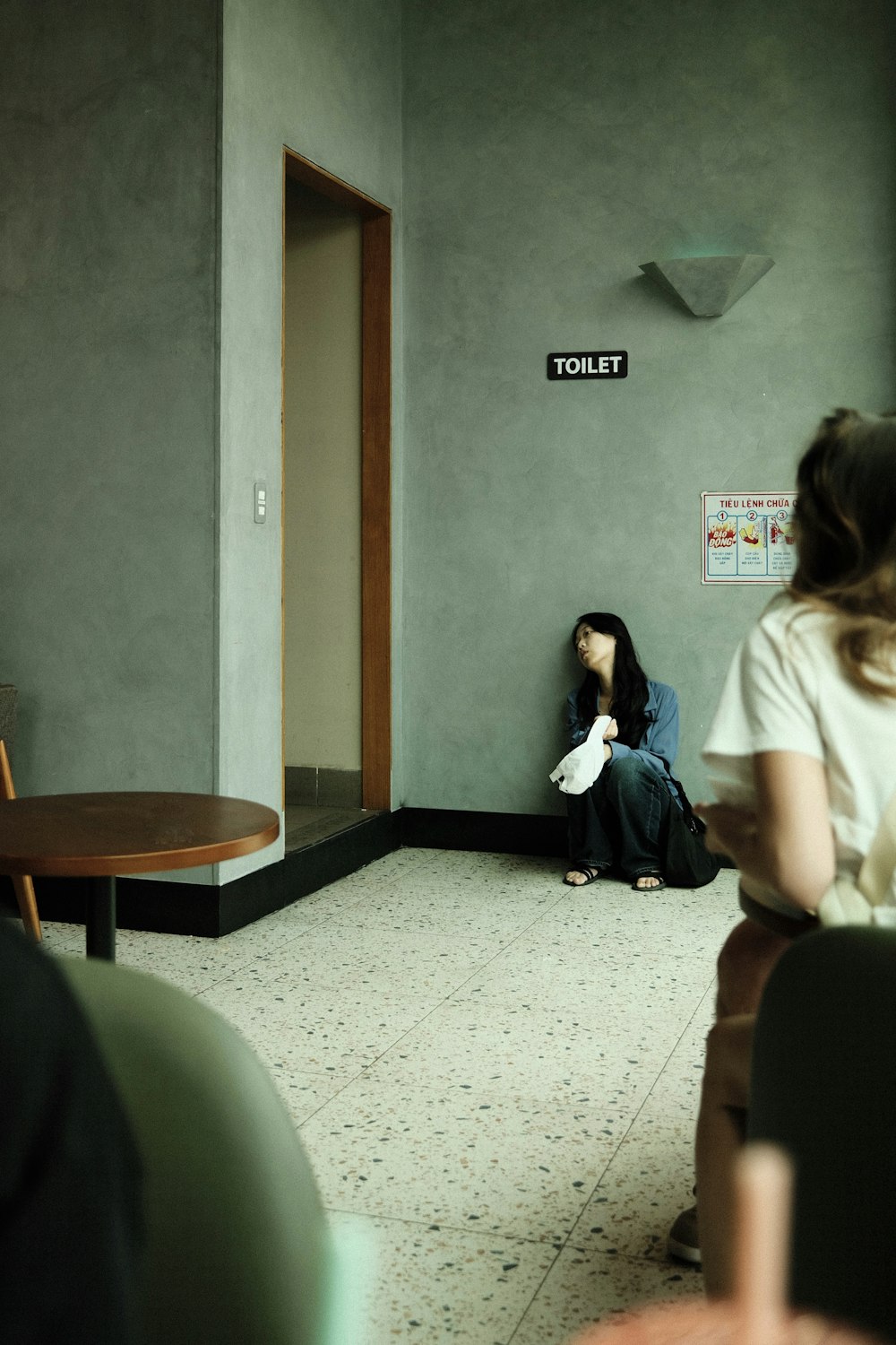 a woman sitting on the floor in a room