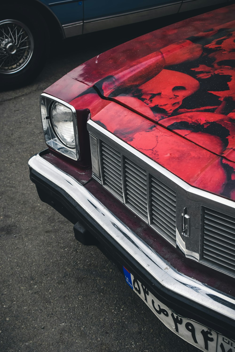 a close up of a red car with skulls on it