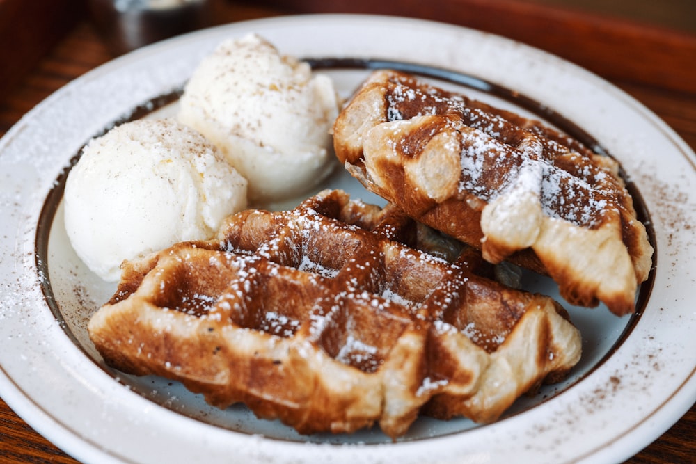 a white plate topped with waffles and ice cream