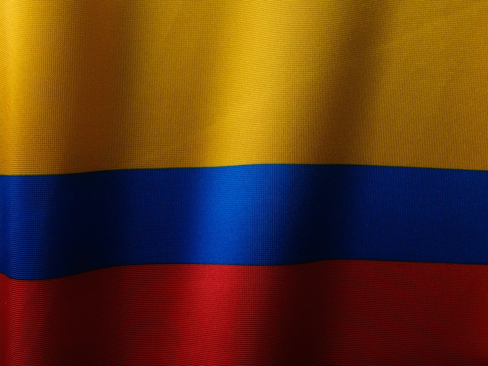 a close up of a red, yellow and blue flag