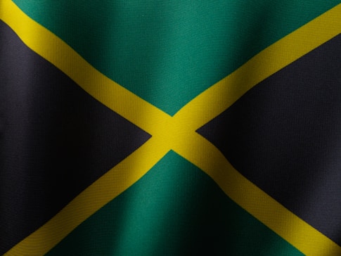 the flag of jamaica is waving in the wind