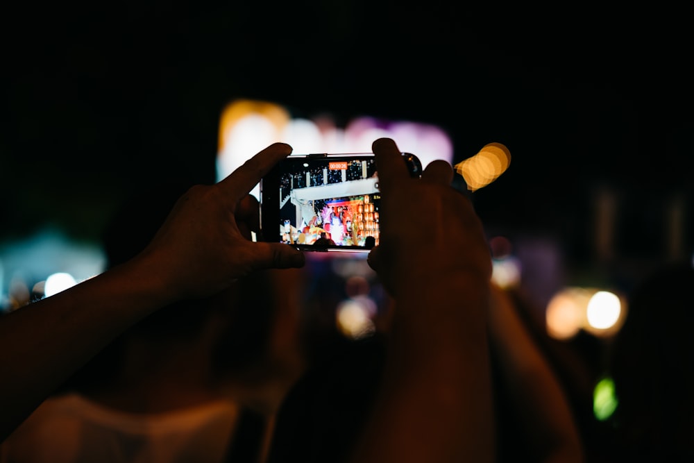 a person taking a picture with a cell phone