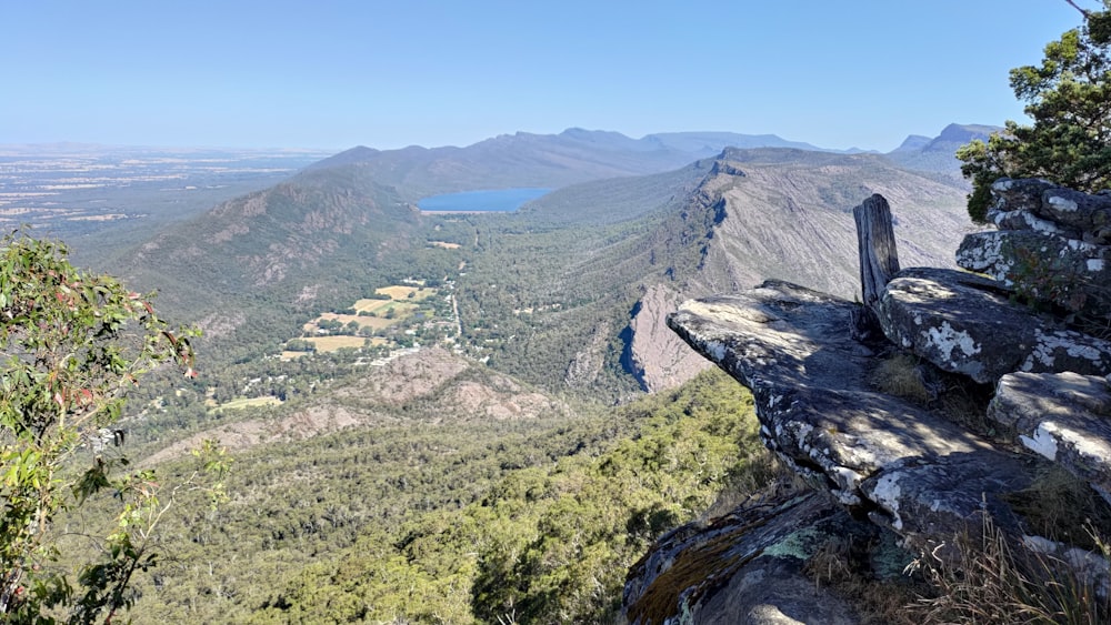 a view of a valley and mountains from the top of a mountain