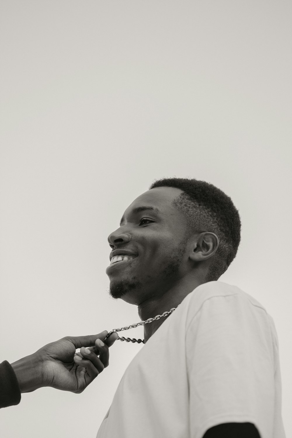 a black and white photo of a man getting his teeth brushed