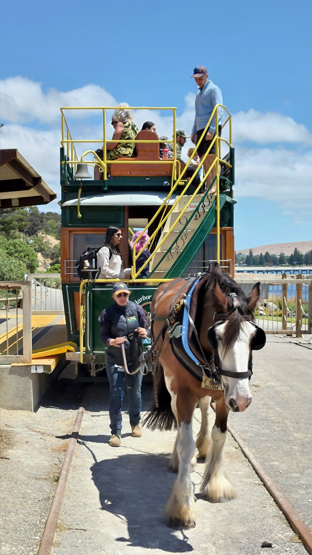 a horse pulling a trolley with people on it